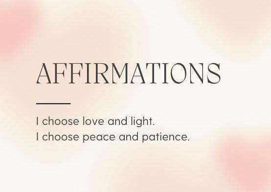 Handwritten poetry affirmations for positivity beside fresh flowers